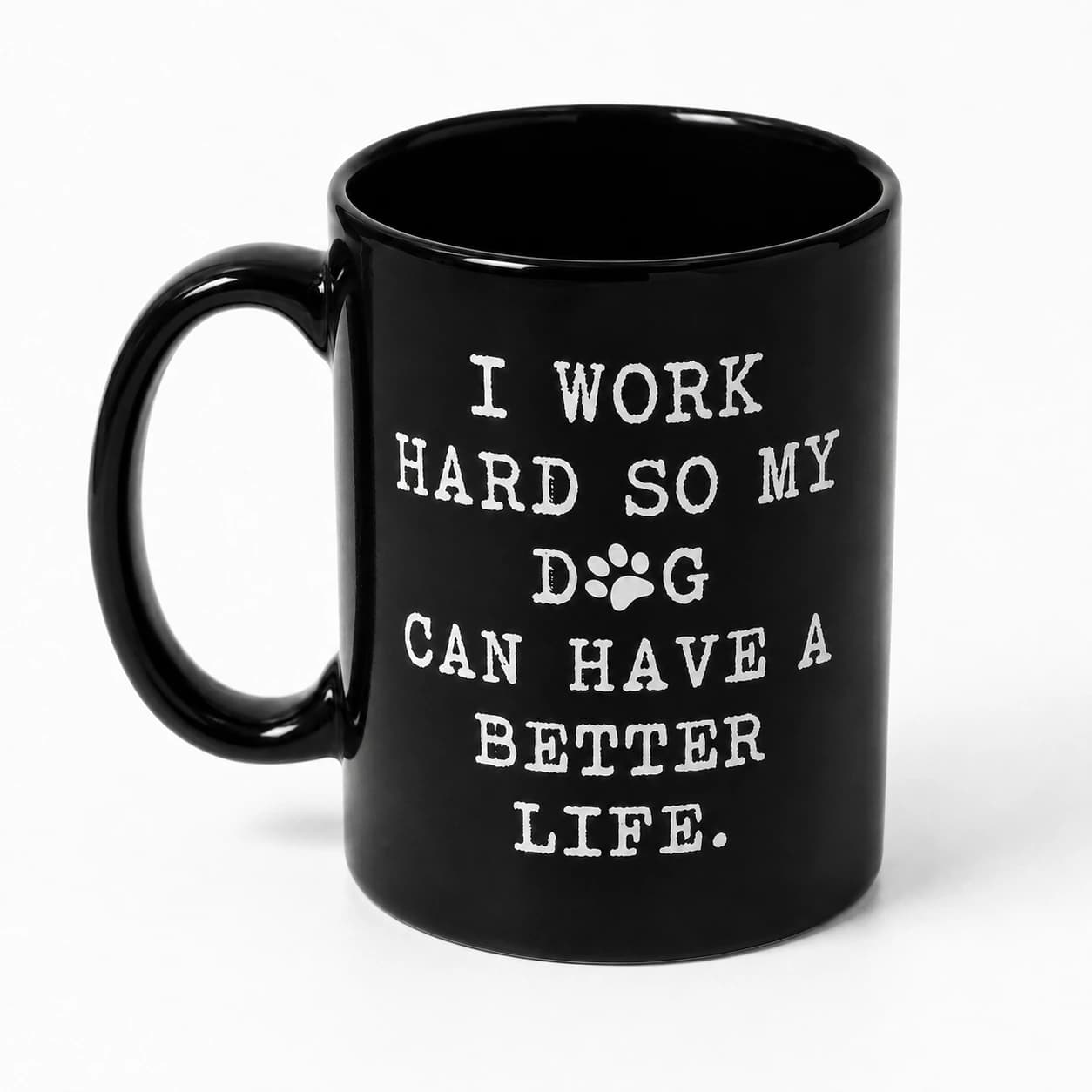 Angled studio view showing the black glazed interior of the A Better Life for My Dog Mug, with its original white slogan on glossy black ceramic