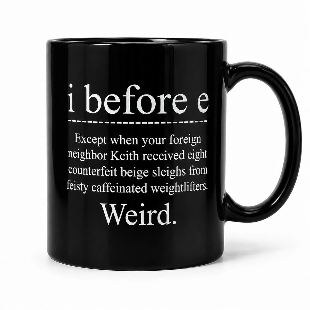 Front studio view of the I Before E — Weird Mug, with its original white slogan on glossy black ceramic